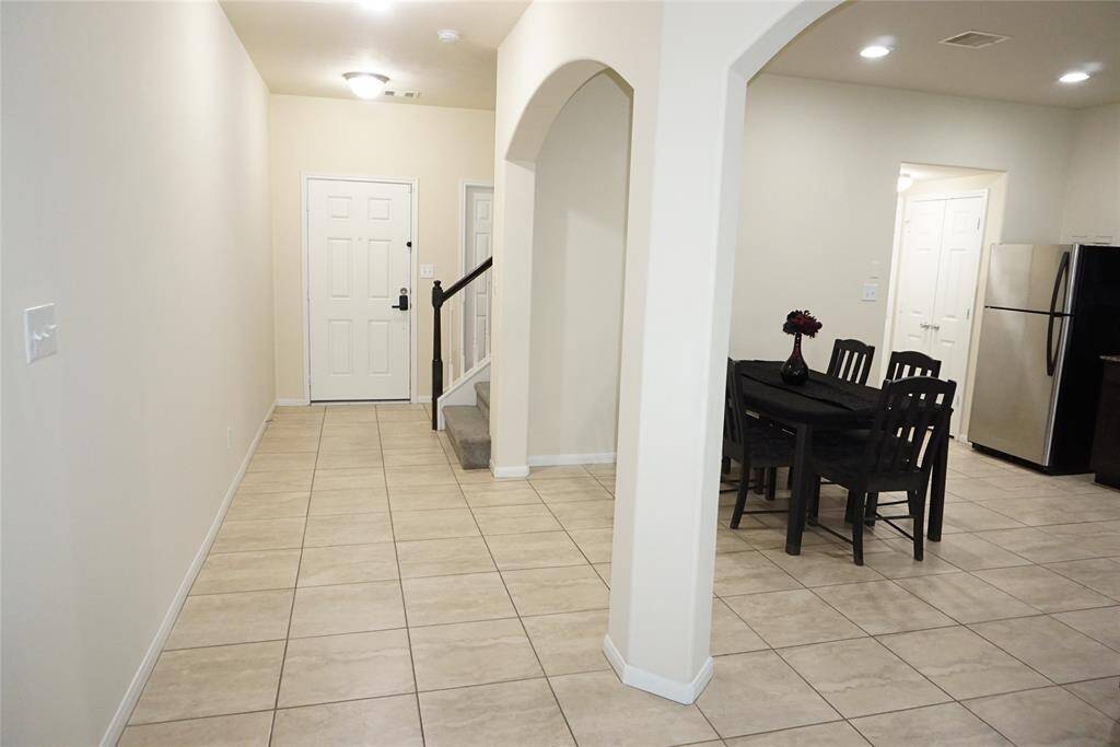 Beautiful open archways separate the kitchen/dining from the entry and family room.
