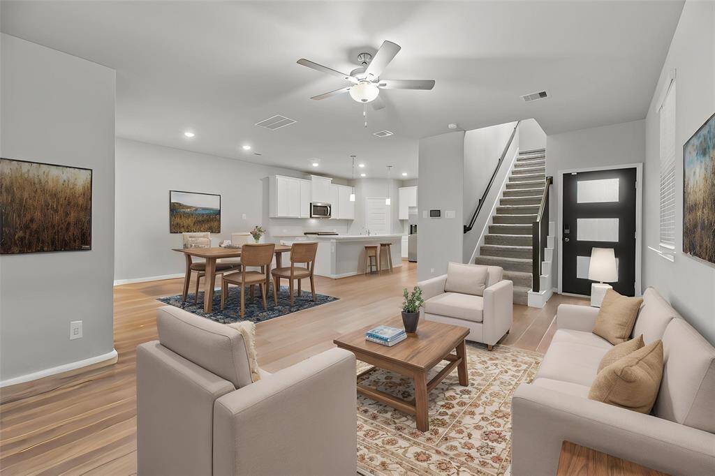 The open-concept living area effortlessly connects to the dining room and kitchen, creating a spacious and inviting atmosphere perfect for entertaining or everyday living. - virtually staged