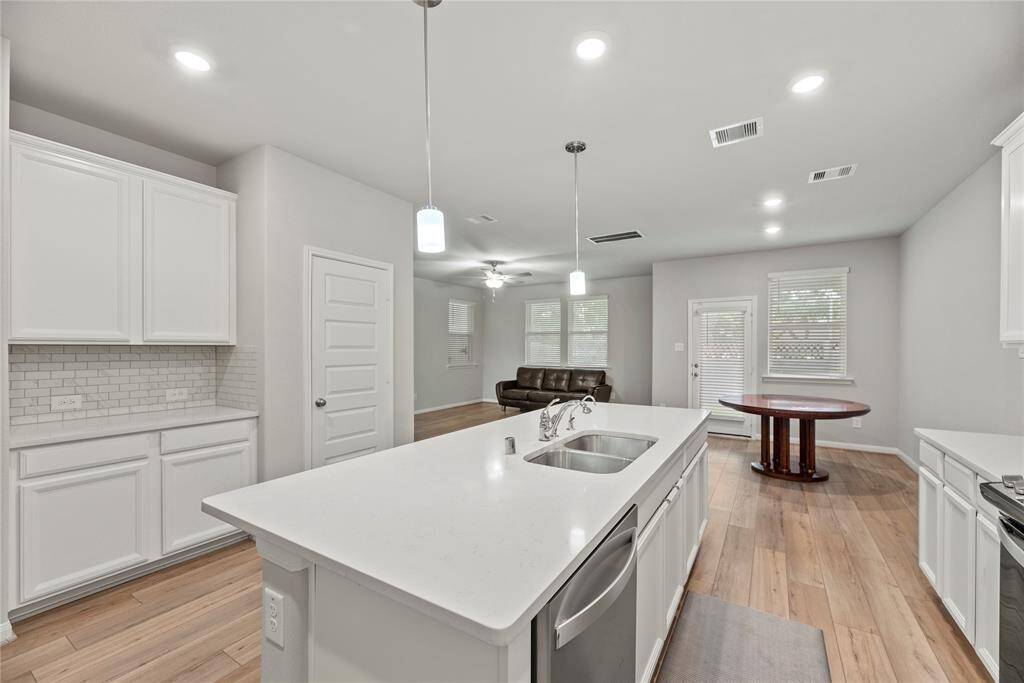 Granite countertops paired with a coordinating stone backsplash not only provide a durable and elegant surface for food preparation but also add a touch of luxury and sophistication to the kitchen.