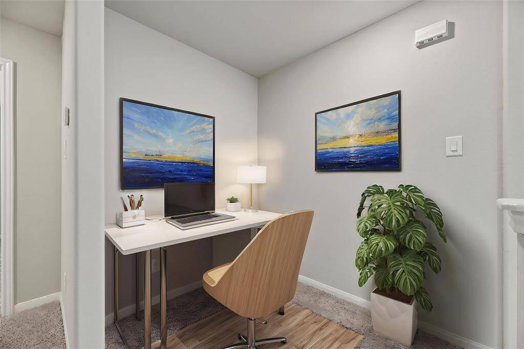 At the top of the stairs, a spacious landing offers a versatile area perfect for a reading nook or additional lounge space. - virtually staged