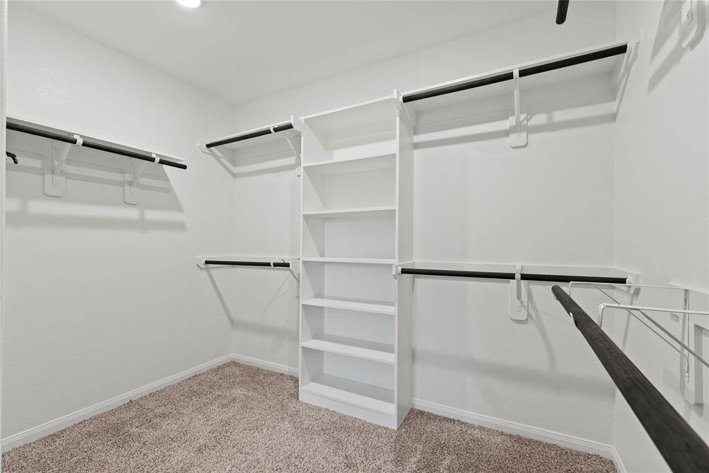 The primary closet provides generous space to store your entire wardrobe while keeping everything neatly organized and easily accessible.
