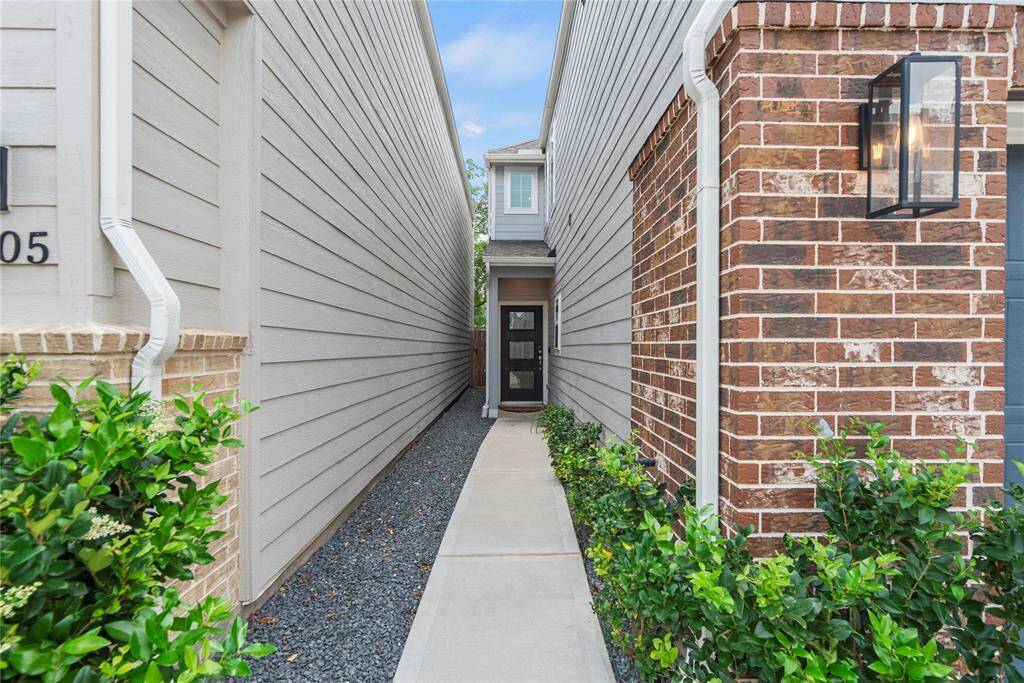 A picturesque side path guides you to the elegant leaded glass front door, adding to the home's welcoming appeal.