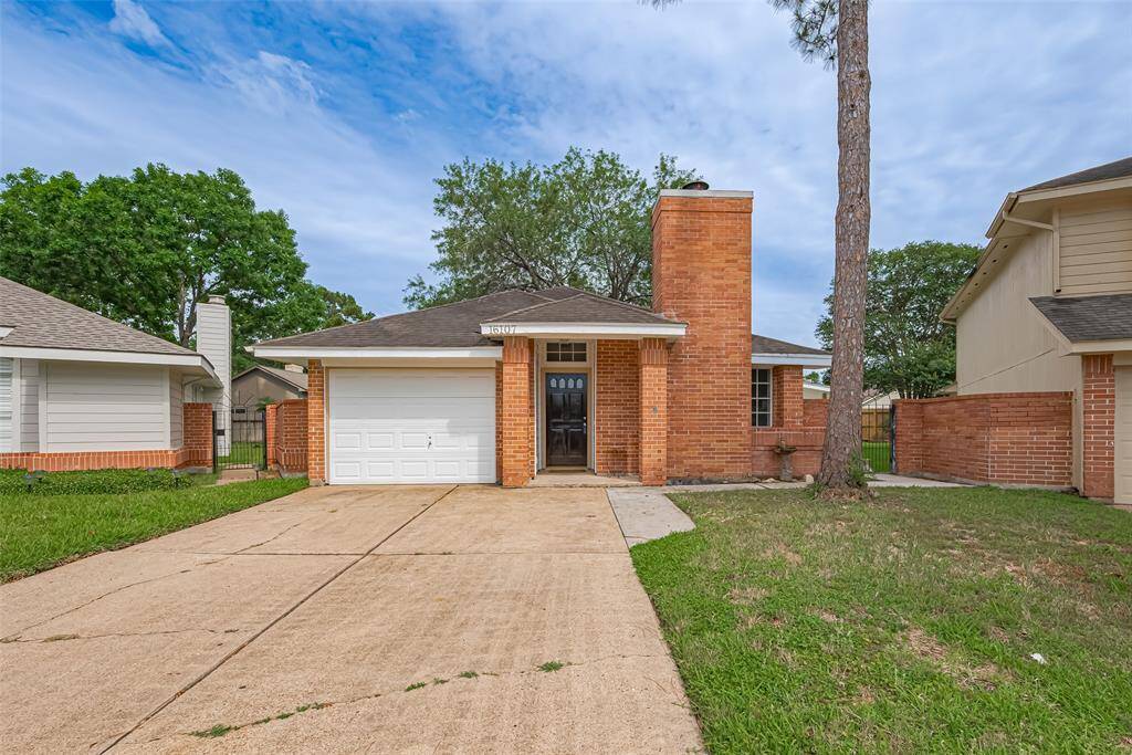 The warm brick façade offers timeless charm, complemented by a crisp white garage door and a neat front lawn. A covered entryway welcomes you.