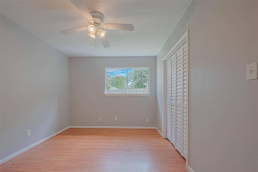 Echoing the home's cohesive design, this room features paneled detailing, a large window, and the same elegant flooring underfoot.