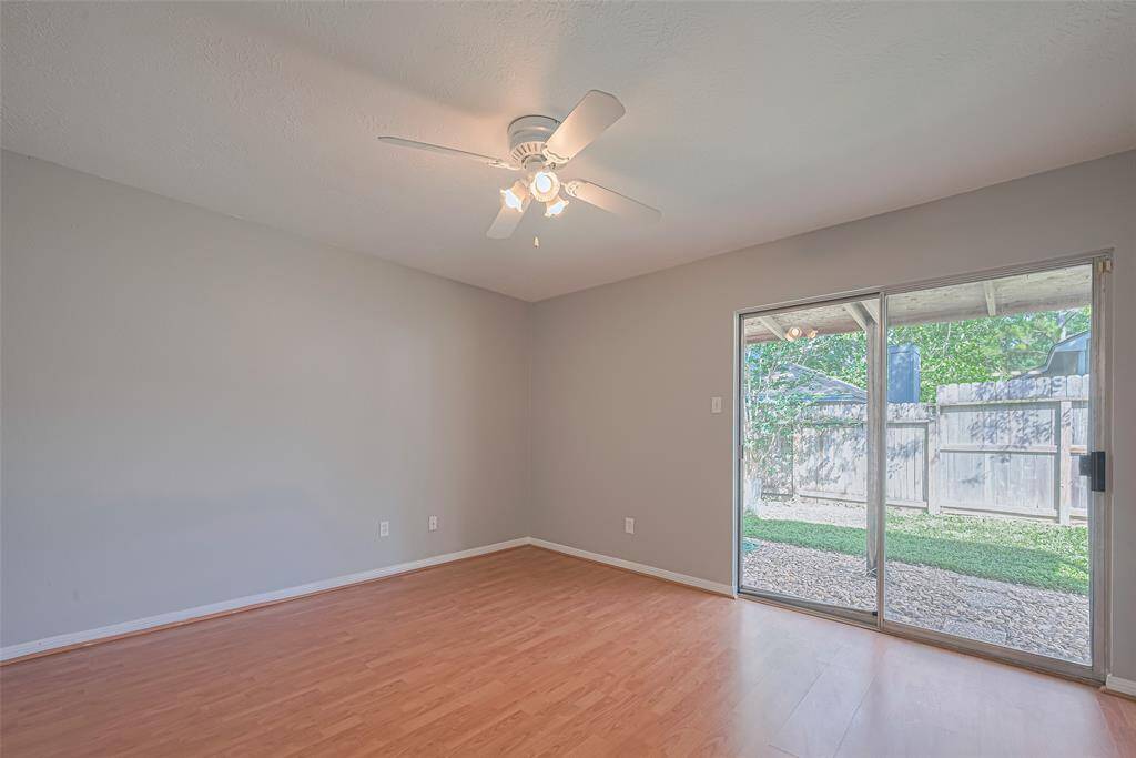 Generous in size and bathed in natural light, the primary bedroom offers a private escape with direct access to the outdoors.