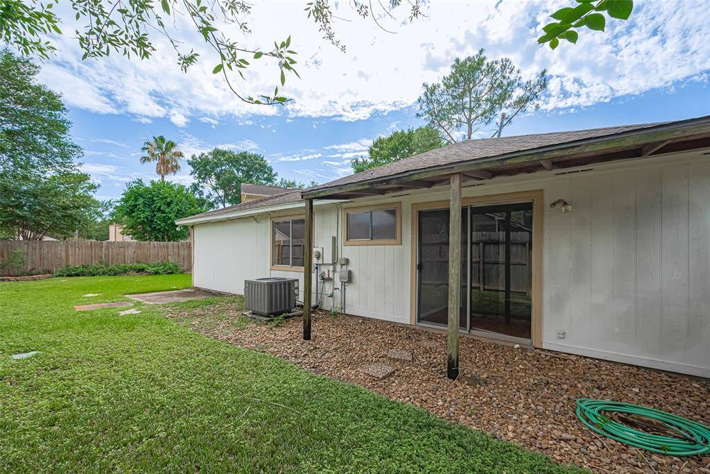 Another covered area awaits just off the primary bedroom—private and serene, this quiet space looks out over the rolling green lawn.