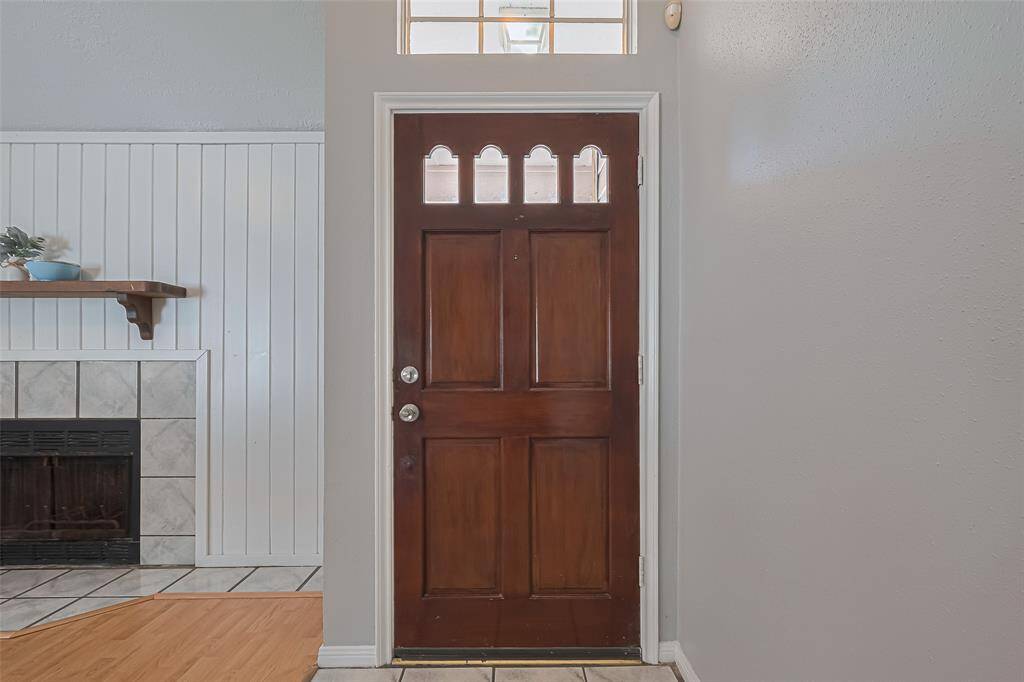 Step inside to a wide, airy view: the entry opens effortlessly into the living area, where high ceilings and long sightlines create a spacious first impression.