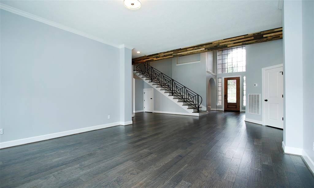From this sitting area, enjoy a clear view of the full staircase leading to the second floor and the main door, creating an open and inviting space.