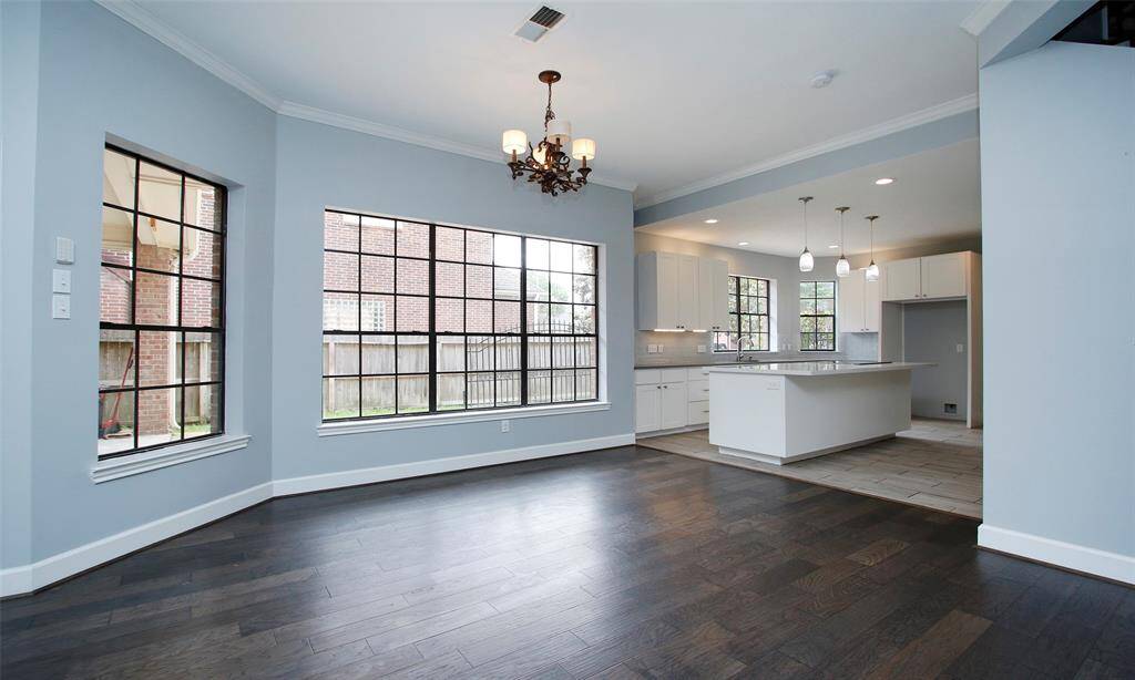 The kitchen features expansive windows, allowing plenty of natural light to brighten the space, just like much of the home.