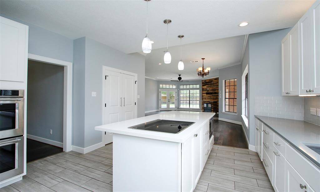 An additional view of the kitchen highlights its open connection to the family room; the closed door leads to the pantry for added storage.