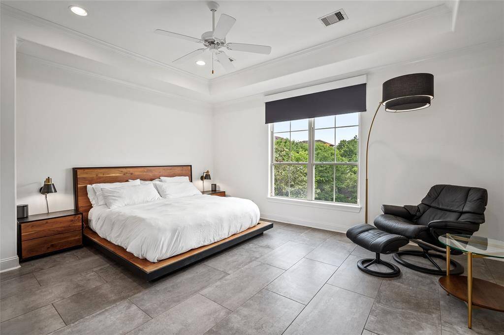 Primary bedroom with updated tile flooring