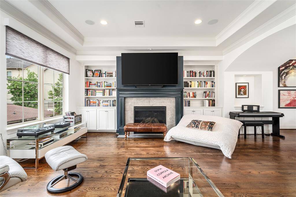Gas Log Fireplace, built in shelving, tray ceilings and tons of natural lighting