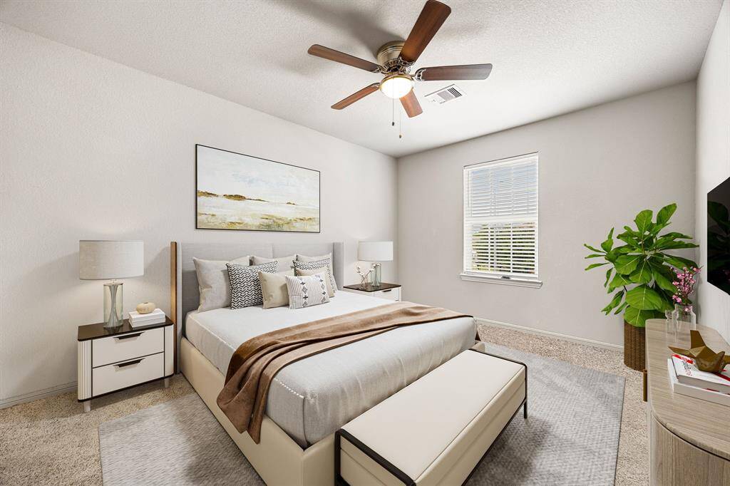 Bright and inviting, this secondary bedroom features plush carpeting, a generous closet, and a wide window that bathes the space in soft natural light, ideal for guests or family. *Virtually Staged