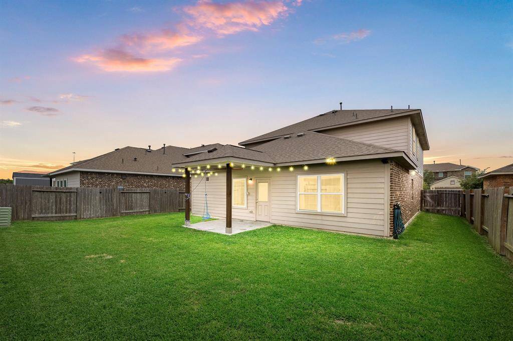 Experience resort-style serenity every evening this twilight-lit backyard showcases a glowing pool, manicured landscaping, and a spacious patio that invites unforgettable sunset gatherings under a canvas of soft, ambient sky.