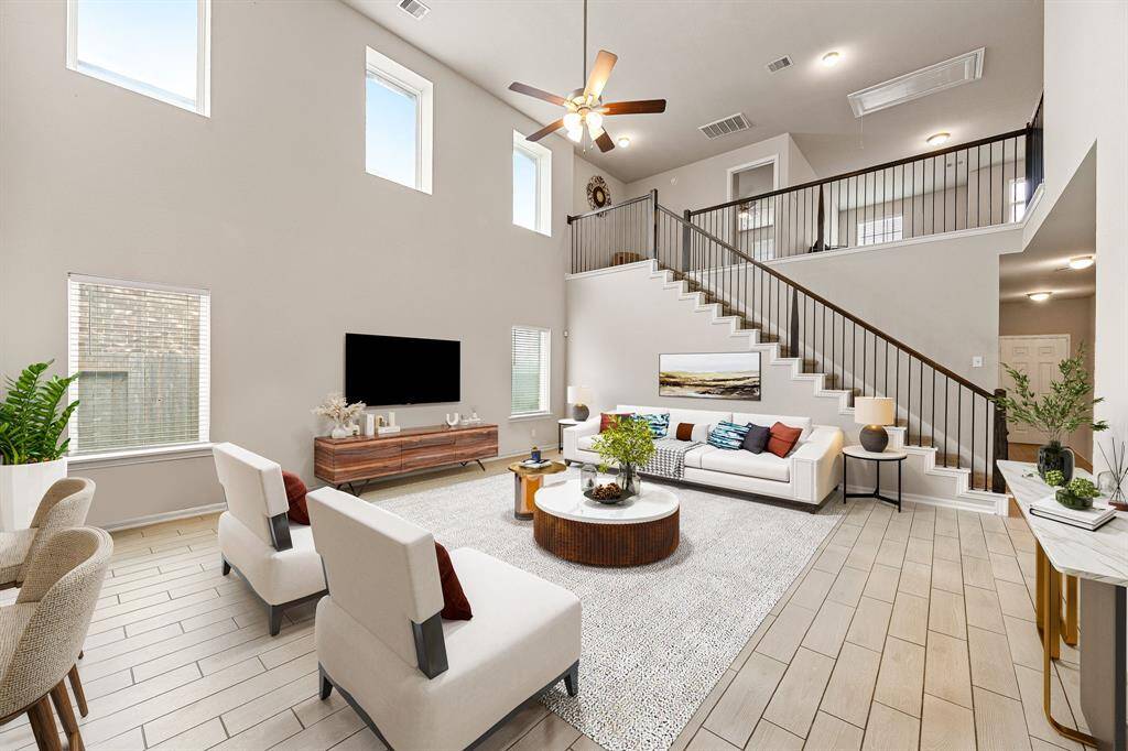 Gather the family and guests together in your lovely living room! Featuring soaring high ceilings, recessed lighting, dark stained ceiling fan, custom paint, gorgeous tile floors and large windows that provide plenty of natural lighting throughout the day. *Virtually Staged
