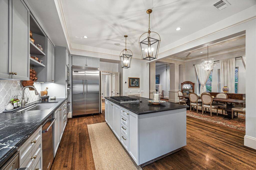 A spacious and functional layout with abundant cabinetry, a double oven, and modern pendant lighting—every detail designed for beauty and utility.