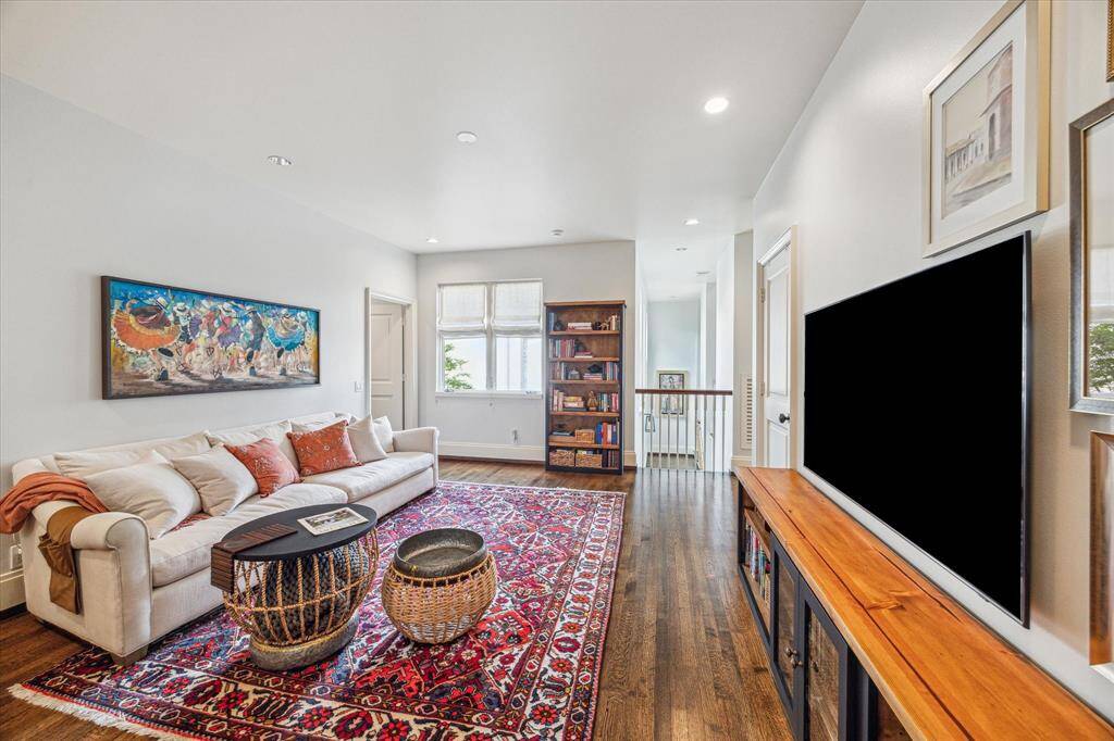 A bright and inviting upstairs game room perfect for casual lounging, movie nights, or play.