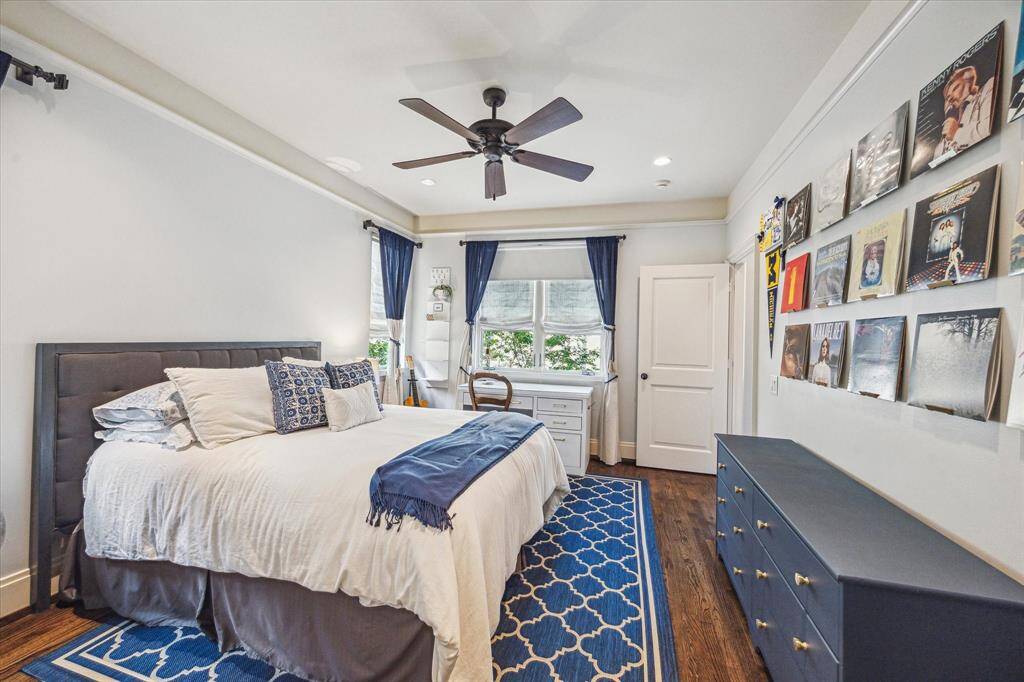Charming and character-filled, this secondary bedroom features rich wood floors, crown molding and is en suite.