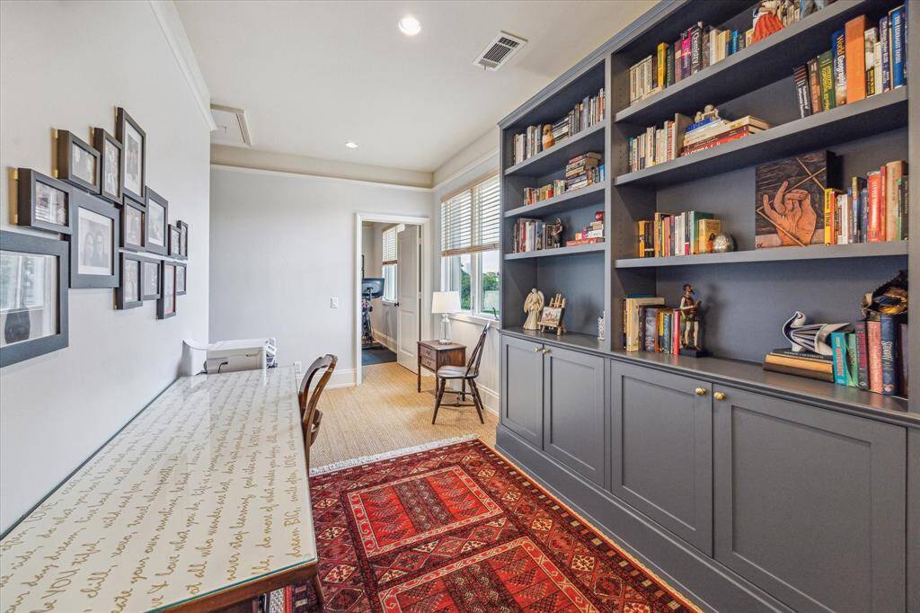 Charming 3rd-floor flex space with built-in cabinetry and bookshelves.