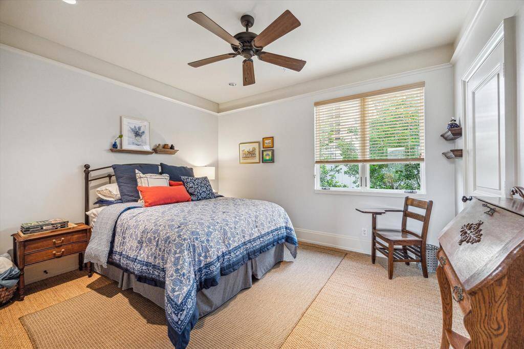 Comfortable secondary bedroom with stylish seagrass flooring flooring, recessed lighting, crown molding, ceiling fan, and access to a Hollywood bathroom.