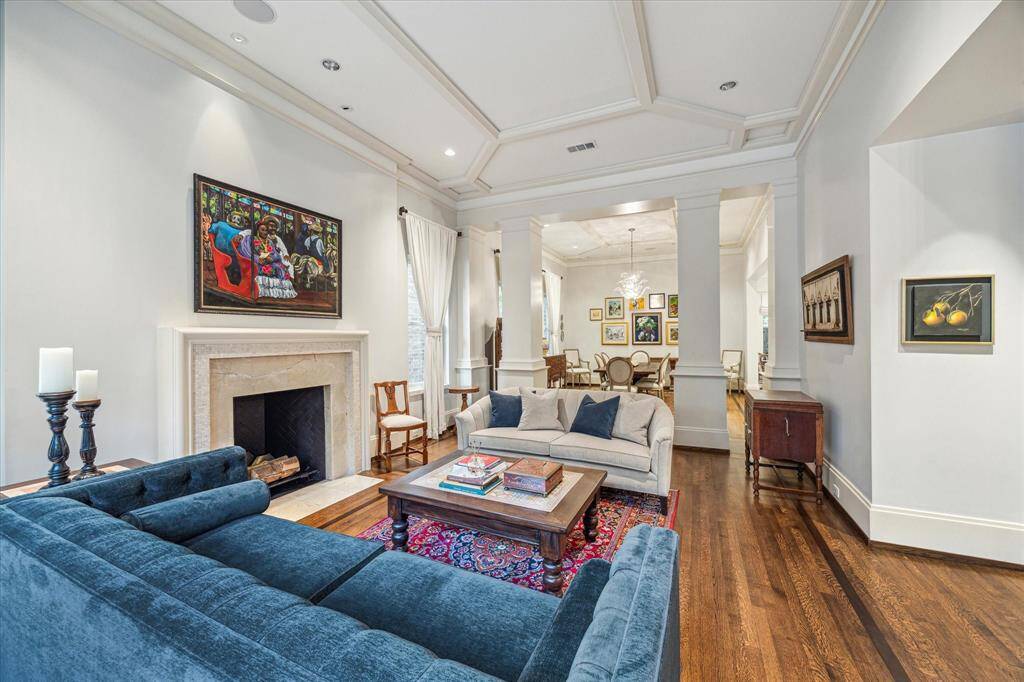 Classic architectural details meet effortless charm in this light-filled living area, with a clear line of sight into the gracious formal dining room.