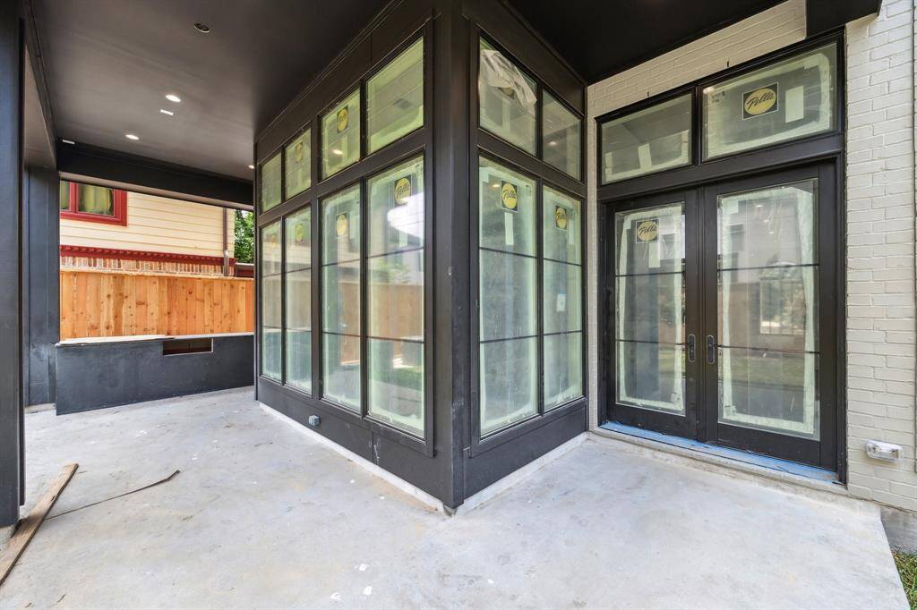 Back patio of the home with a built-in grill.
