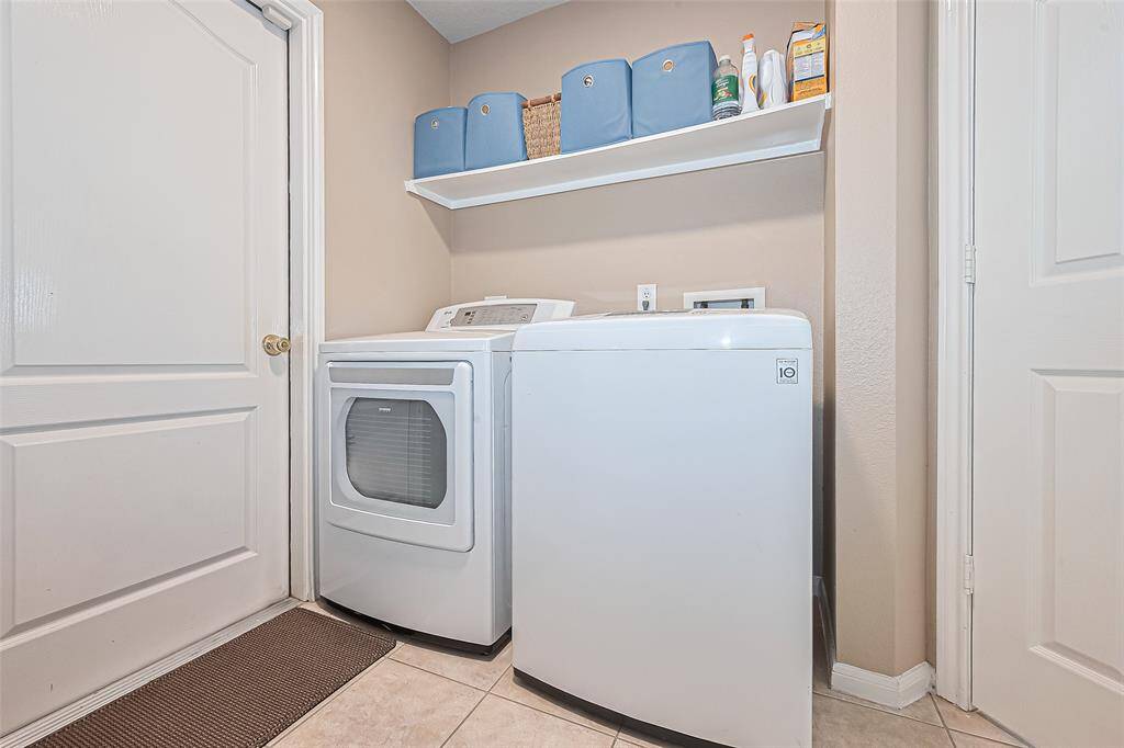 View of the utility room with ample storage.
