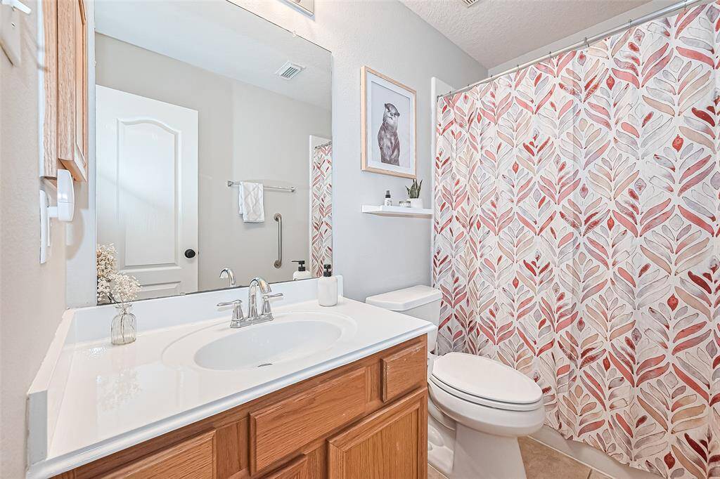 Secondary bathroom features a shower/tub combo.