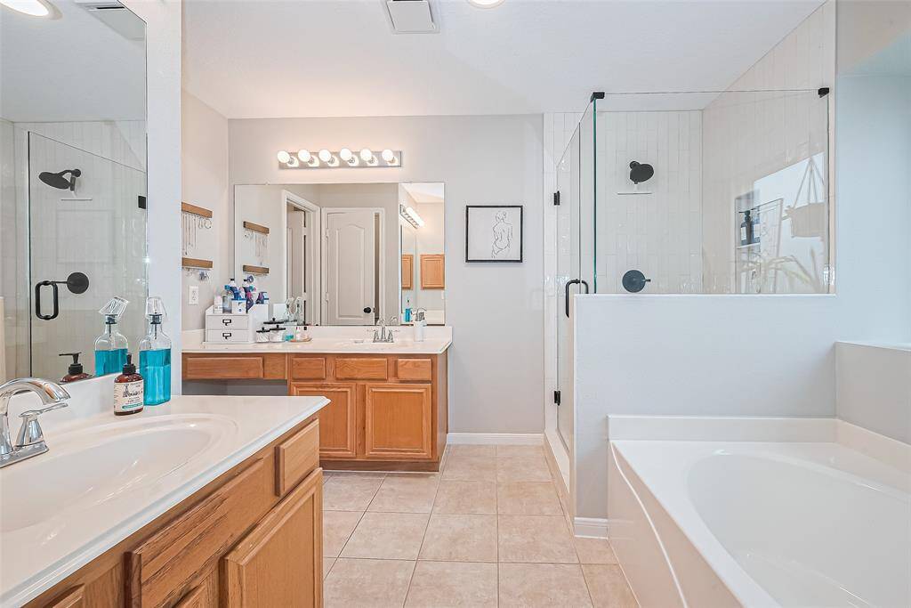 Primary bathroom features large tub and brand new shower!