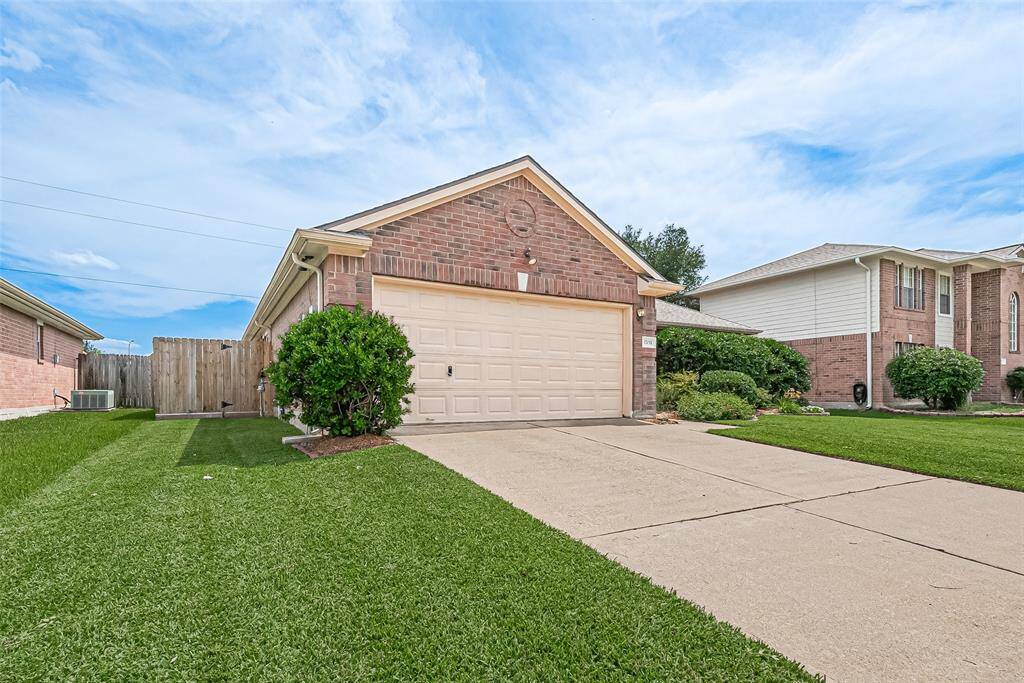 Home features two car garage and wide driveway.