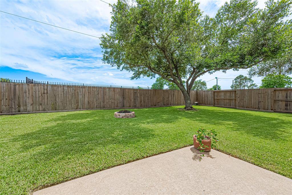 View of backyard featuring new fence.