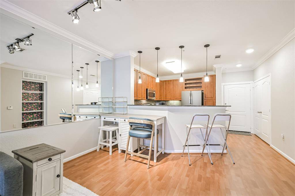 There is space for a table if desired but, the breakfast bar provides room for bar stools. Mirrored wall makes this space feel bigger!