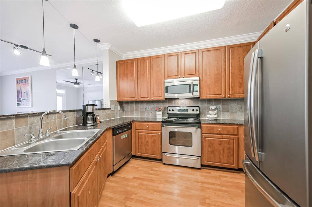 The kitchen features pretty cherry cabinets, granite counters and stainless appliances.