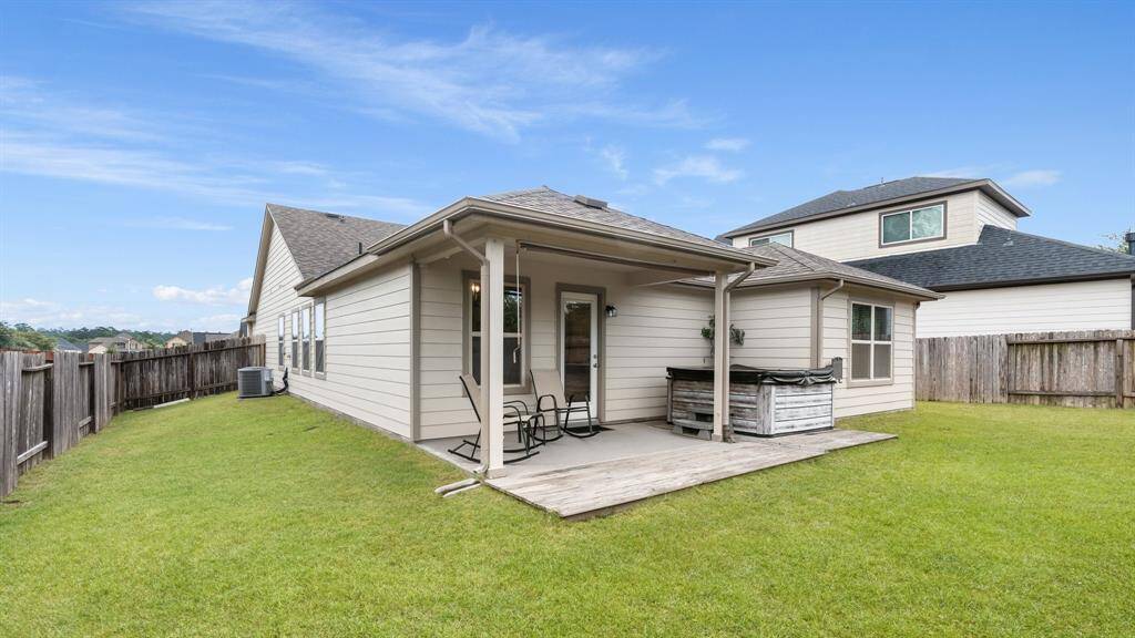 covered patio, hot tub and a fenced-in back yard perfect for relaxation and outdoor activities.