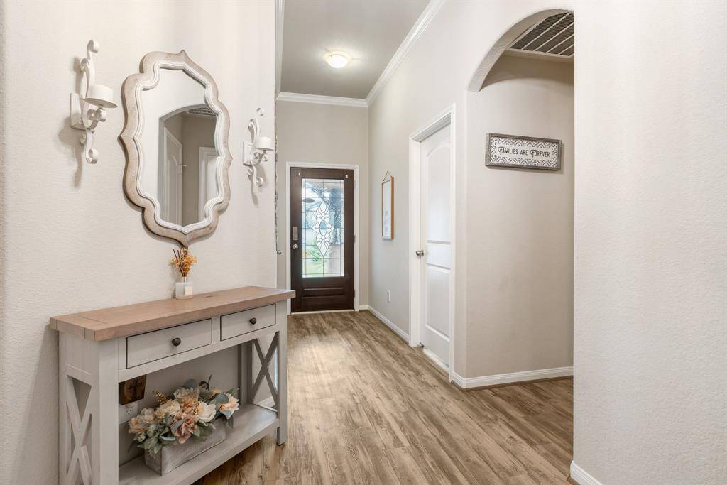 brightened by a glass-paneled door, creating a warm, welcoming entryway.