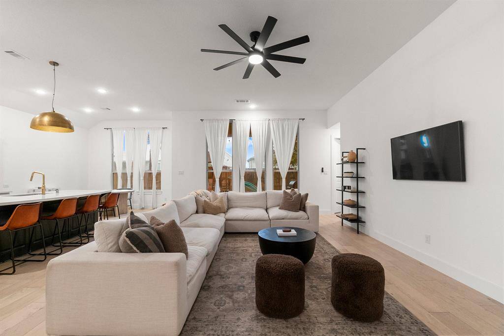 The Family Room exudes warmth and comfort, highlighted by three expansive windows that frame picturesque views of the backyard. This inviting space is filled with natural light, creating the perfect setting for relaxing or gathering with loved ones. Click on the movie reel icon to view our walk-through video.