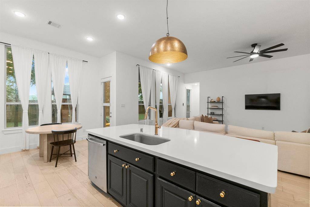The impressive kitchen island serves as the centerpiece of the space, featuring a curved top, striking contrasting wood finish, generous storage, and casual breakfast seating. With ample room for meal prep or buffet-style entertaining, it’s as functional as it is stylish. Our walk-through video is coming soon!