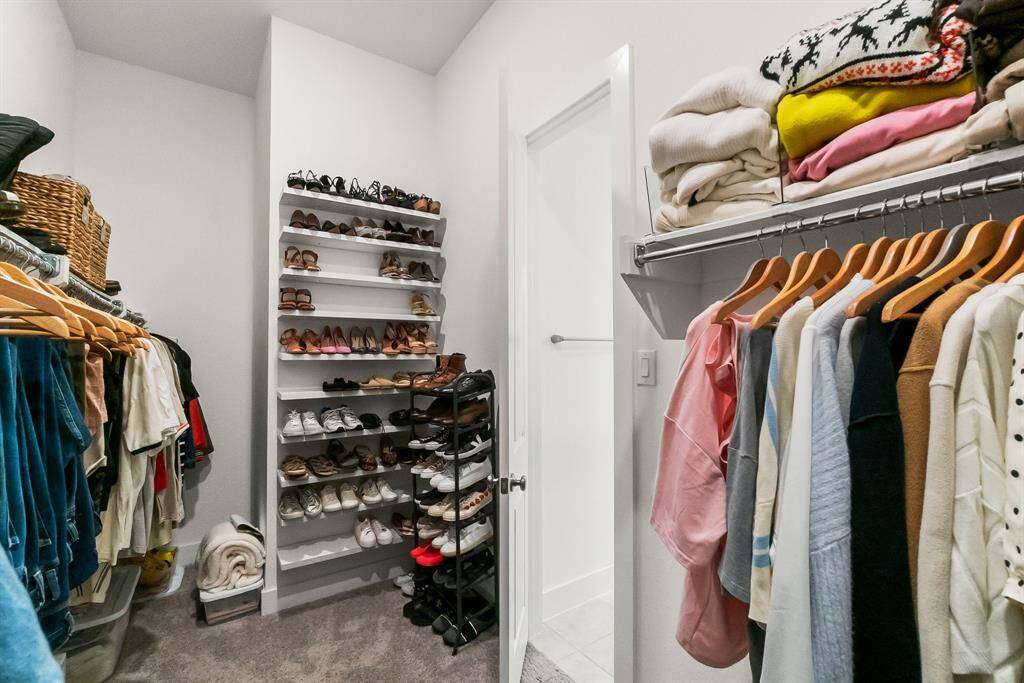 The HUGE walk-in closet is a suite unto itself, offering ample hanging space on three sides and additional built-in shelving.