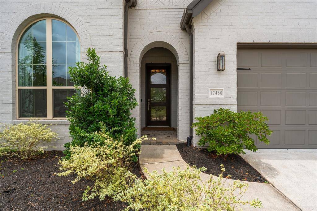 Luxury starts at the gorgeous covered front porch, featuring an arched entry, brick flooring, and a stately wood and seeded glass front door that makes a lasting first impression. Intricate brickwork, blooming landscaping, and gorgeous lighting hardware complete the picture.  Inside, this custom home is packed with high-end details throughout, offering a perfect blend of elegance and comfort.