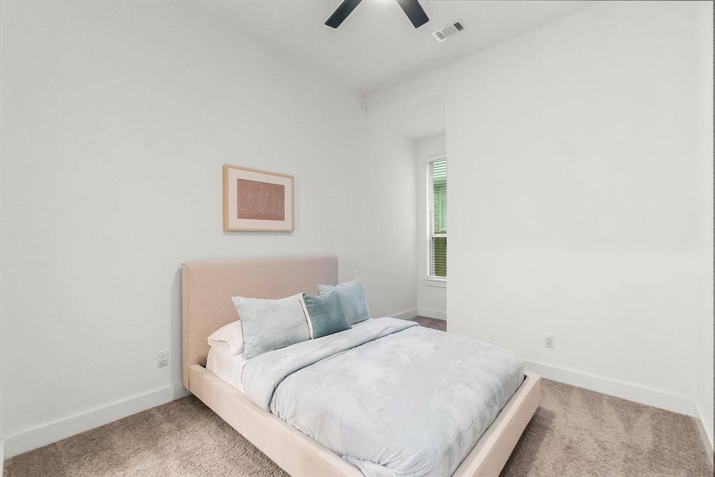 Three additional bedrooms are located in a quiet area of the home for privacy. This bedroom features lush carpeting, spacious walk-in closet, sunny window with blinds, and lighted ceiling fan. It has direct access to its own private en-suite bath.
