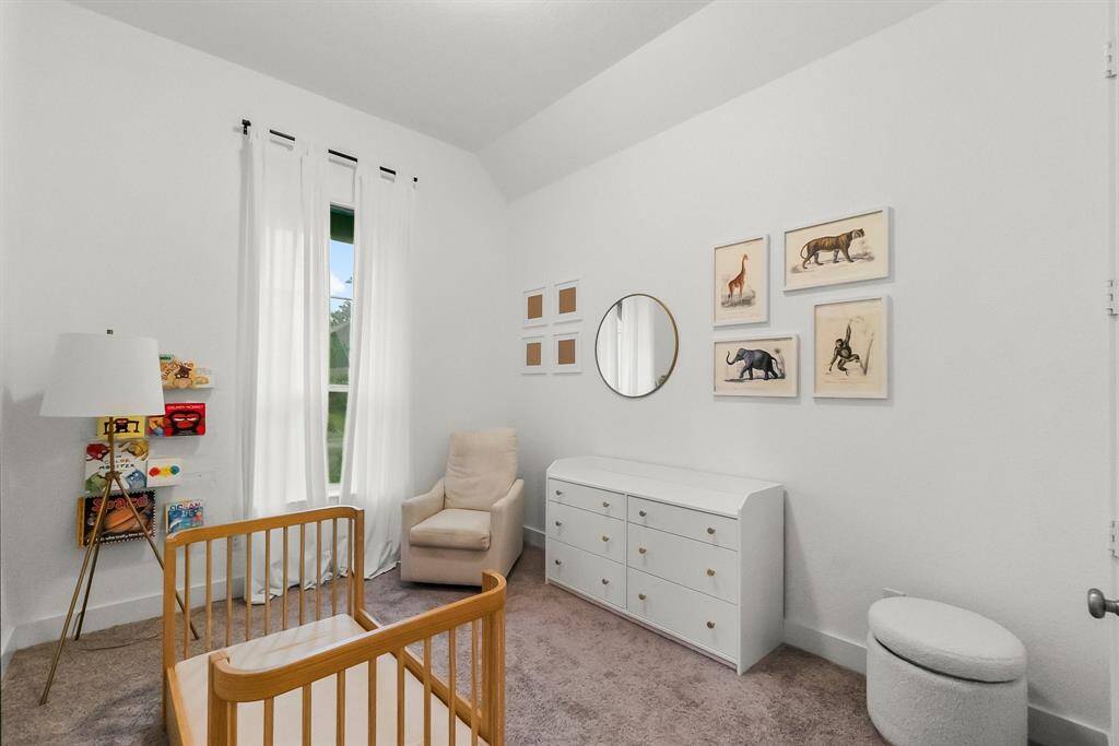 Another secondary bedroom offers lush carpeting, walk-in closet, sunny window, sloped ceiling, and ceiling light.  It has hallway access to a full bath shared with Bedroom 4.