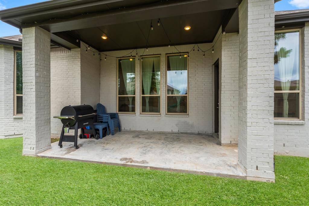 This covered patio with recessed lighting and lighted ceiling fan provides a shaded space to relax and enjoy the view. This outdoor space allows you to sit and lounge while waiting on the grill, enjoying a cold beverage, and watching the beautiful evening sunsets.