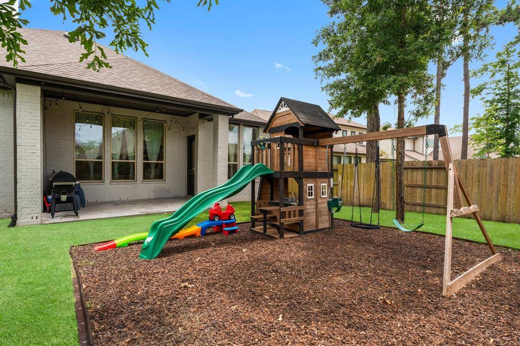 This awesome children's playset is also included. Imagine all the hours of family fun here! The covered porch is a great place to sit and watch the kids play in the yard. Click on the movie reel icon to view our walk-through video of this amazing playset and the backyard!