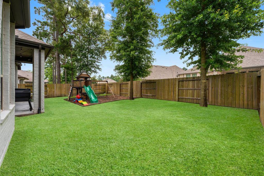 Lots of room to play in this yard. Front and back gutters for easy rainwater management. Whole house irrigation system keeps your yard looking fresh and green!