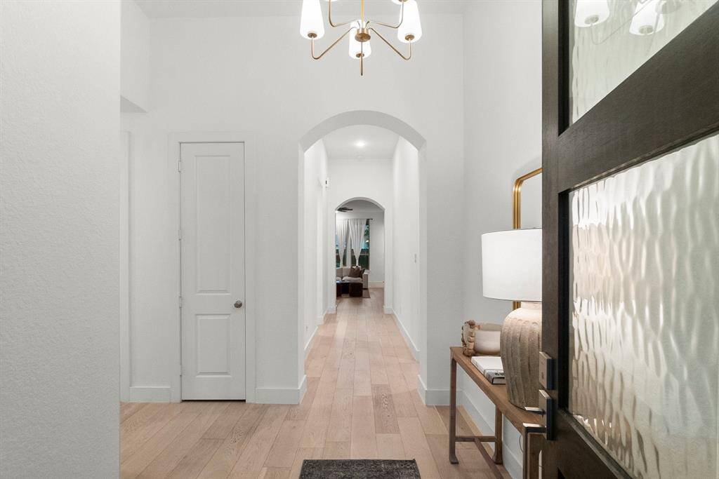 Expansive foyer area with backyard views from Foyer all the way into Den.  Your eye is drawn immediately to the 11' ceilings and arched entryways.  Over-sized baseboards throughout! Three large hallway closets boast additional space for storage, and there is plenty of room for a bench or entry table!