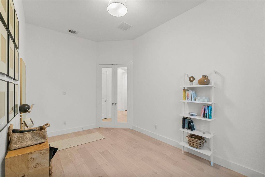 Another view of the study. Glass-front French doors provide both privacy and sound control while maintaining a visual connection to the rest of the home.