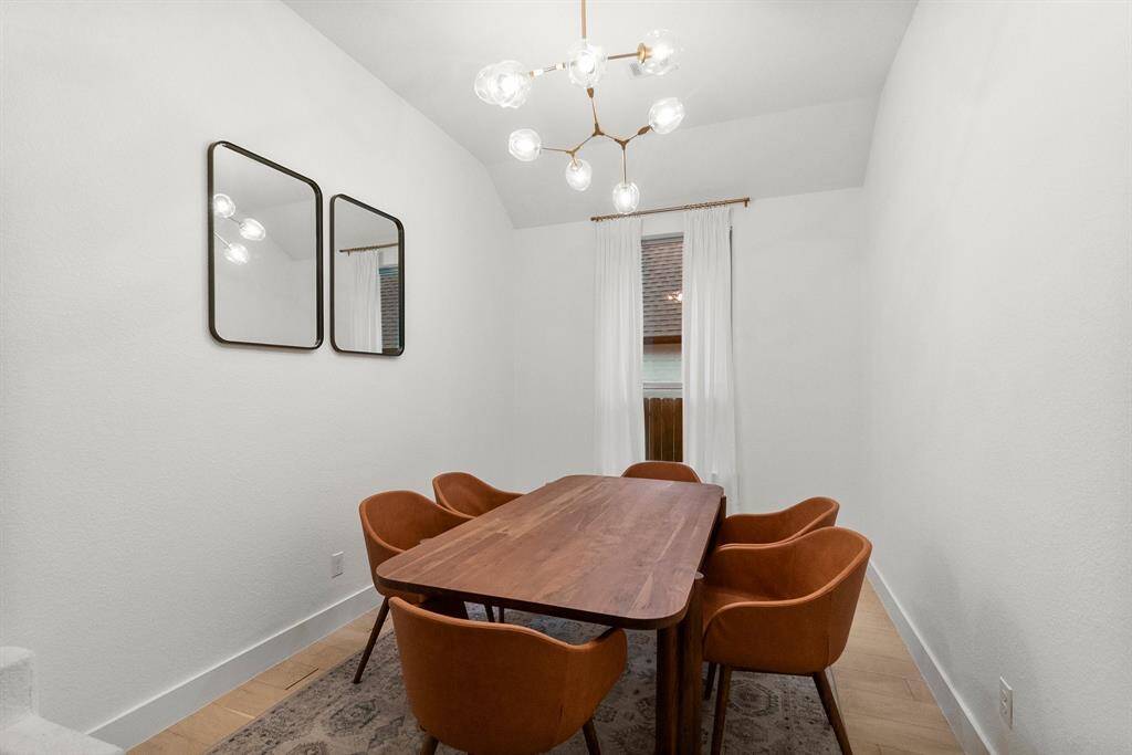 Gather your guests and celebrate in this stunning Formal Dining Room, designed for both grandeur and comfort. It features engineered wood flooring, a sunny window for natural light, 6" baseboards, a sloped ceiling, and a designer chandelier.