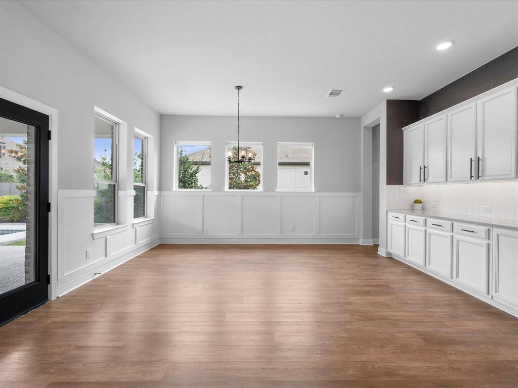 In the Formal Dining Room, it is adorned with wrap-around cabinetry as your buffet!