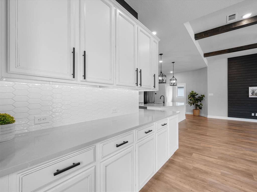 In the Formal Dining Room, it is adorned with wrap-around cabinetry as your buffet!