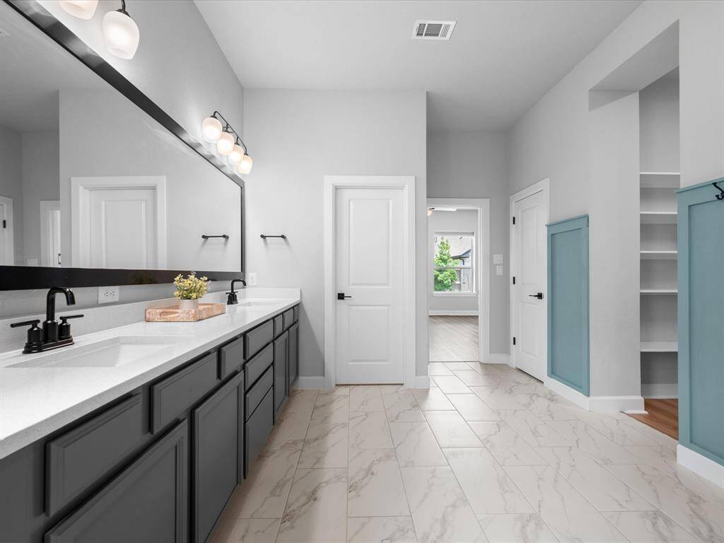 Carrying on from the Primary Bedroom, Board & Batten was customed added to the bathroom walls & above the soaking tub!